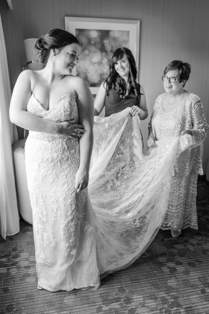 bride, mom, and sister getting ready