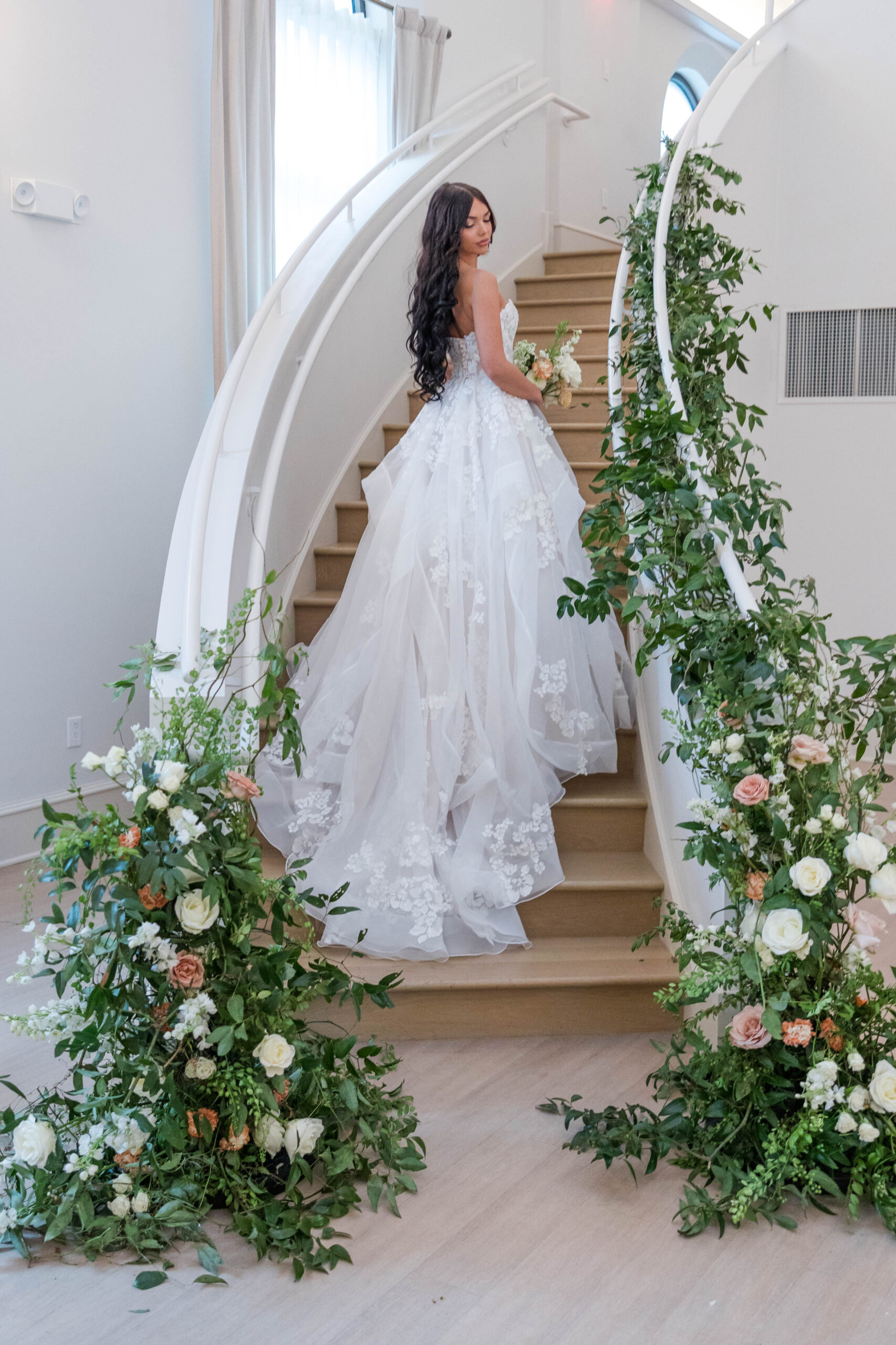 Bride on staircase with florals